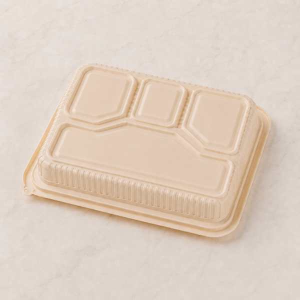 Bottom view of compostable food container showing raised compartment structure