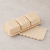 Upside down compostable container displaying structured base and separate flat lid