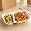 Two compartment bagasse tray serving grilled chicken fries and fresh salad