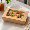 2100ml kraft window salad box filled with pasta salad and vegetables in a café setting